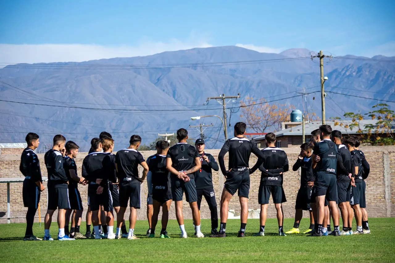 Youth players listening to coach instructions