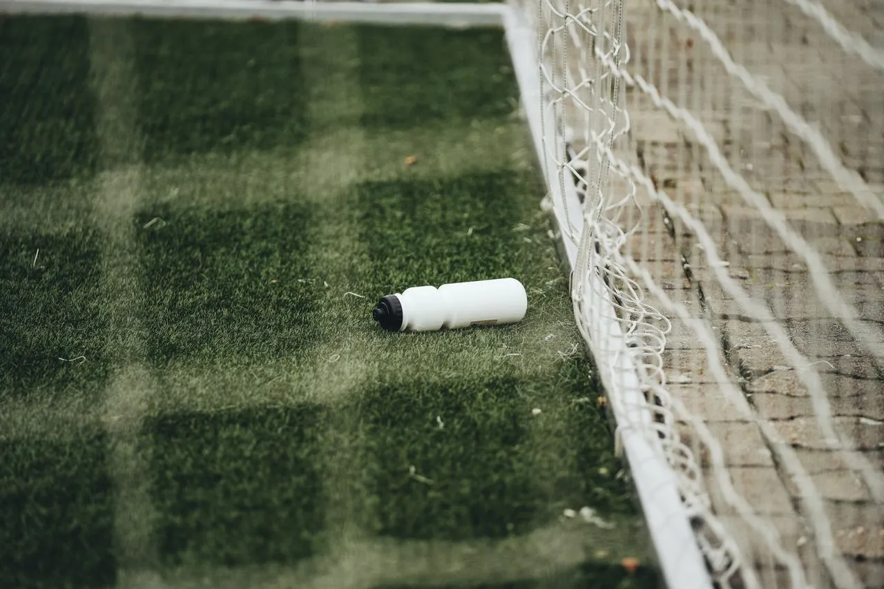Youth soccer players taking a water break on a hot summer day in Vancouver